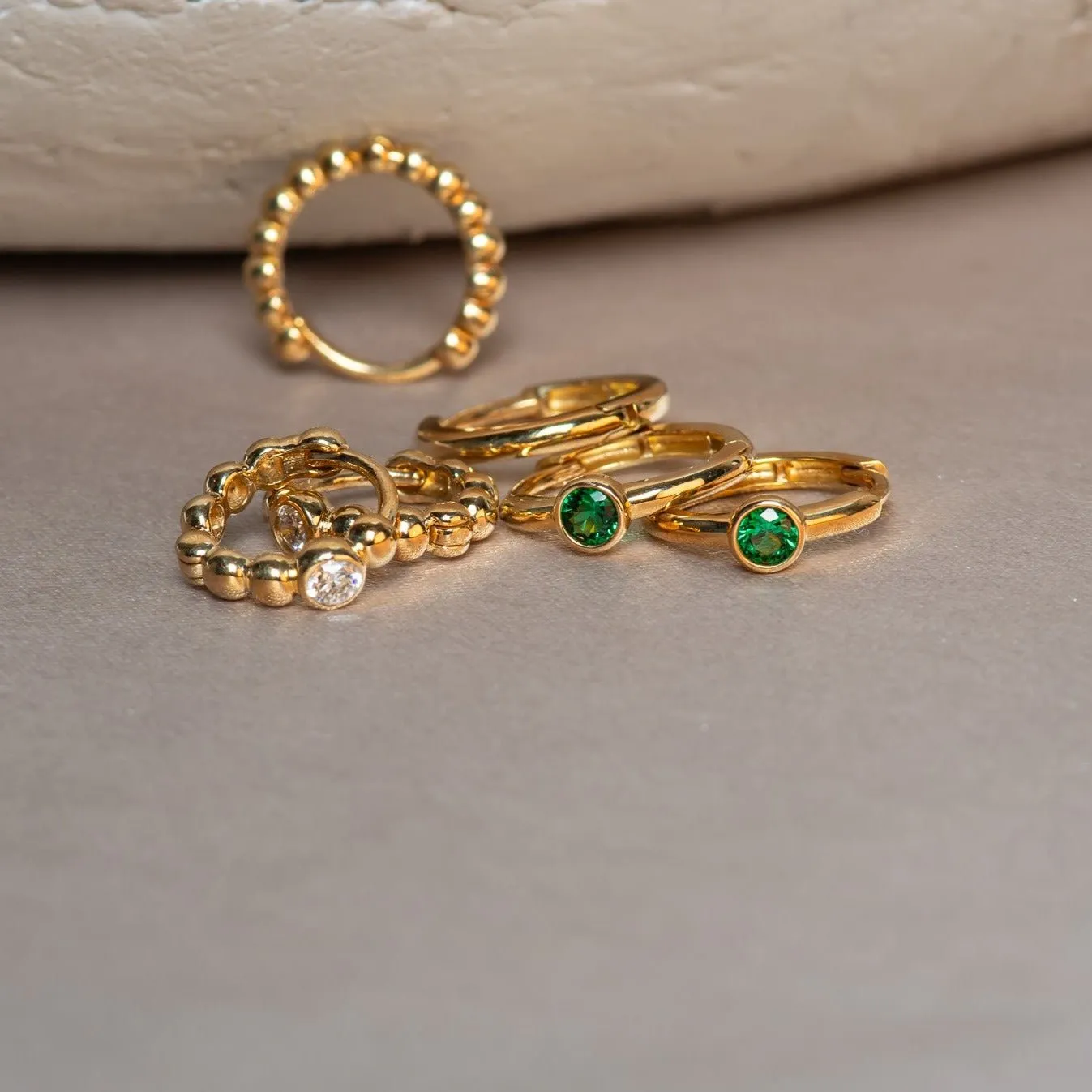 Bezel Set Emerald Huggie in 14k Gold