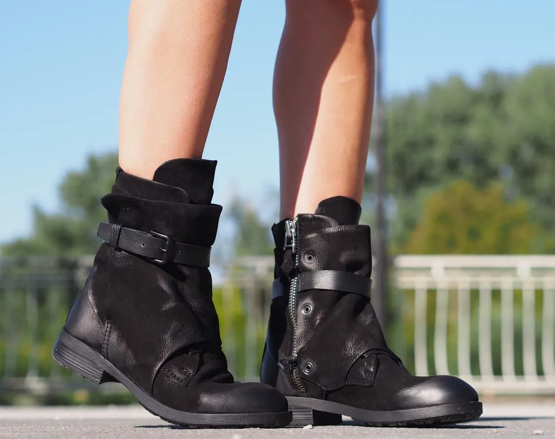 Black leather boots, Genuine women's extravagant leather footwear.