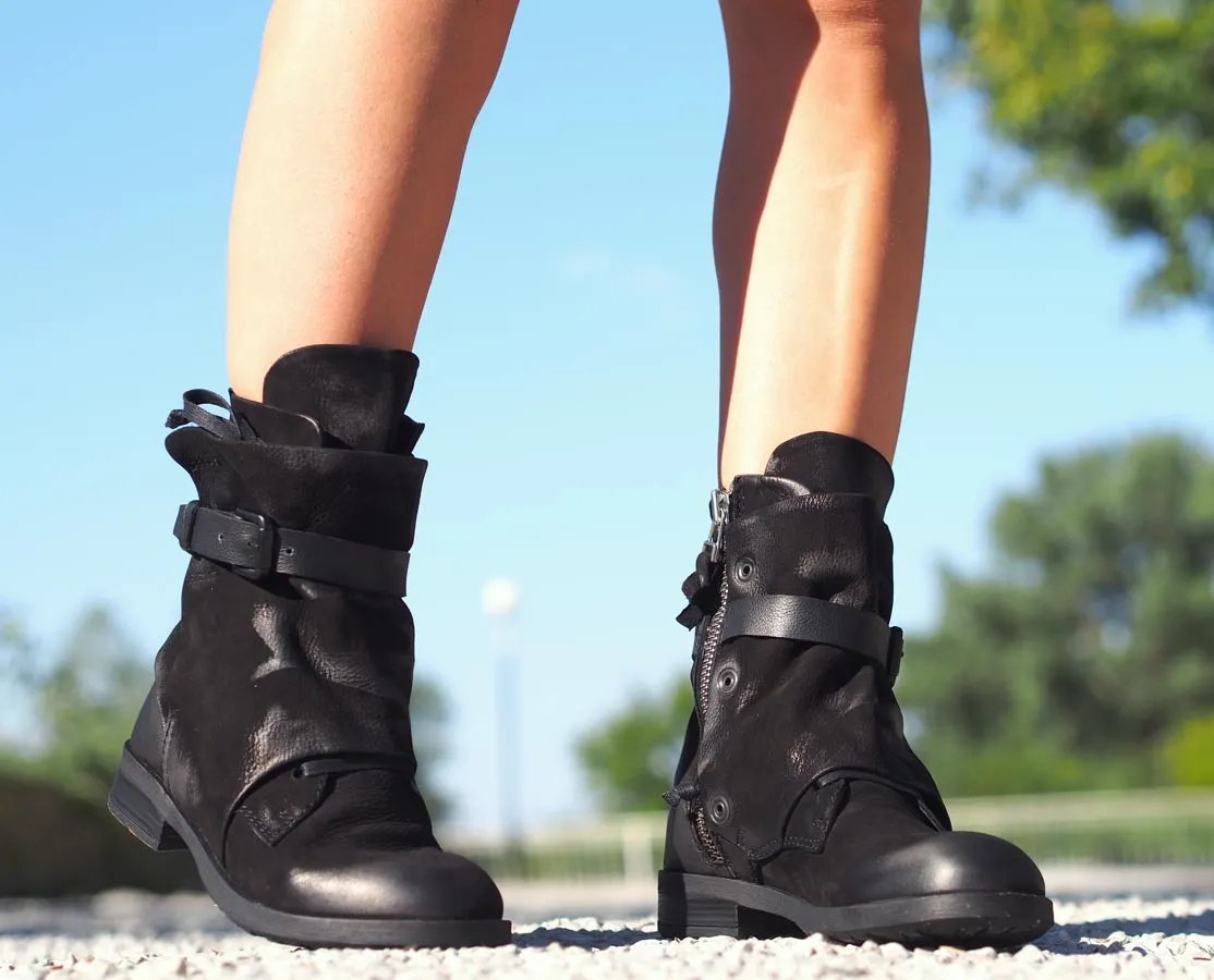 Black leather boots, Genuine women's extravagant leather footwear.