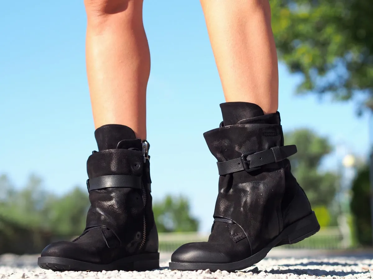 Black leather boots, Genuine women's extravagant leather footwear.