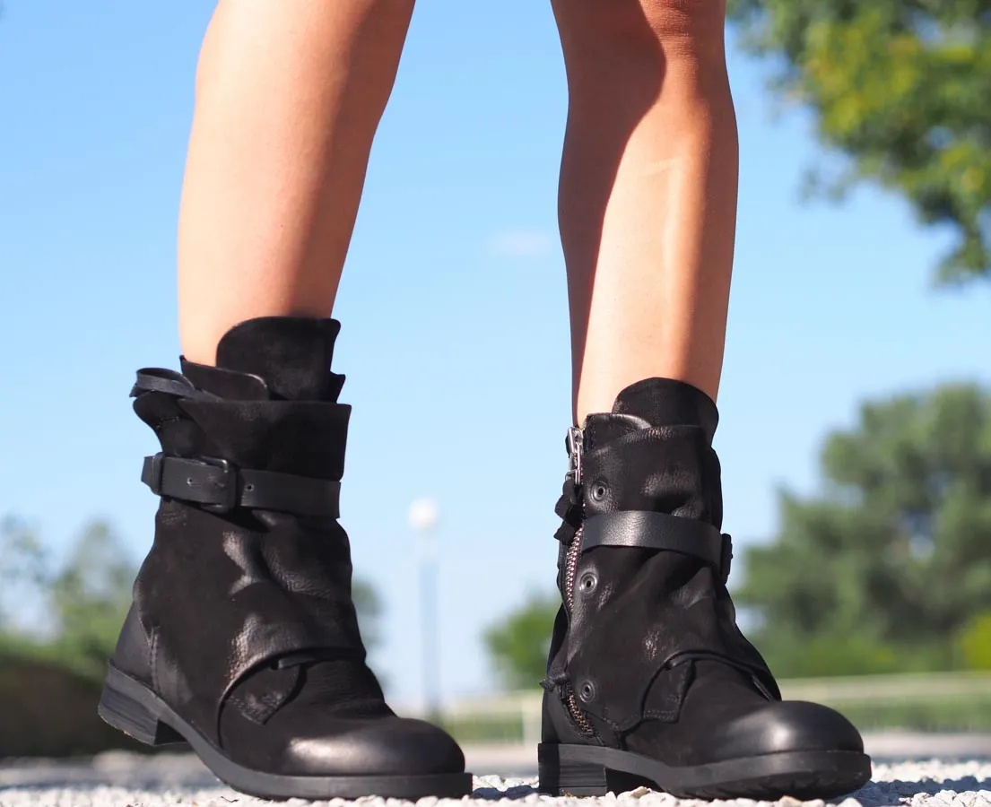 Black leather boots, Genuine women's extravagant leather footwear.