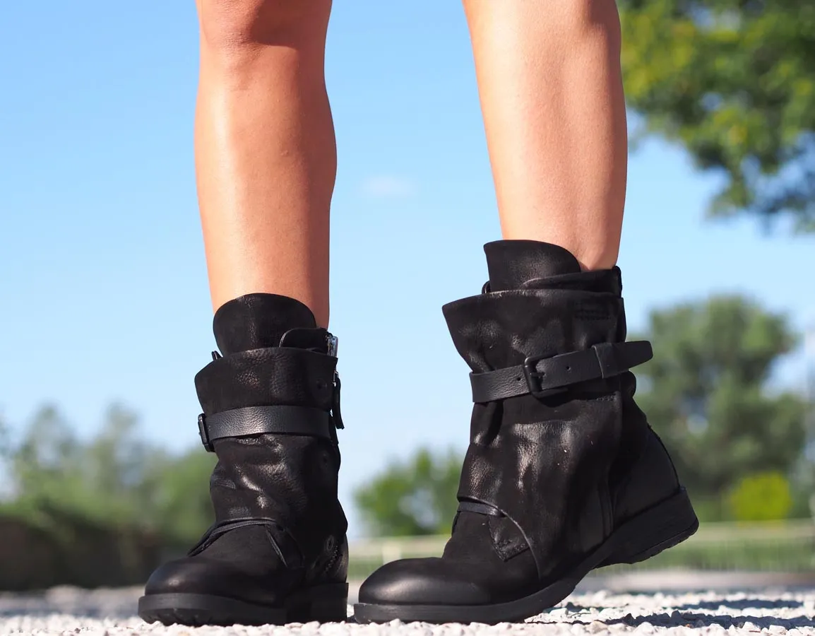 Black leather boots, Genuine women's extravagant leather footwear.