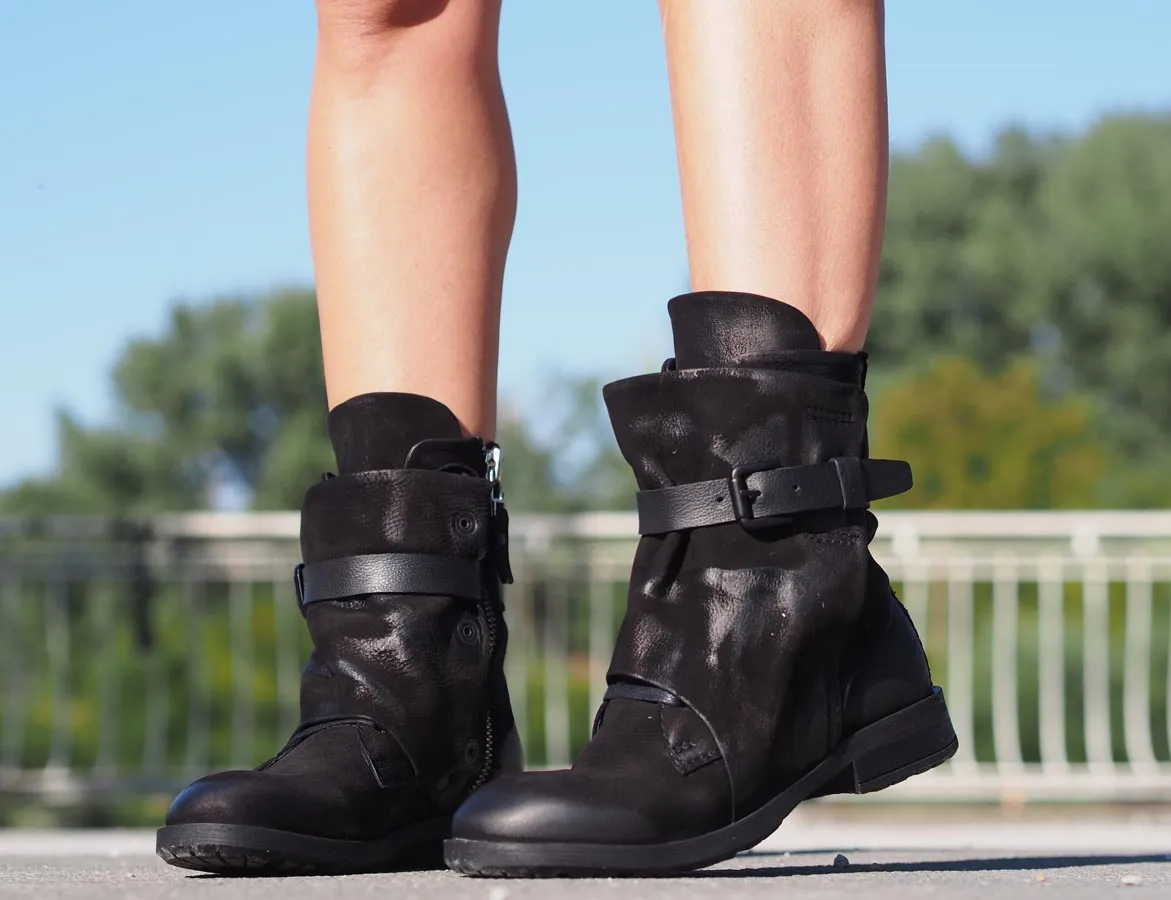 Black leather boots, Genuine women's extravagant leather footwear.