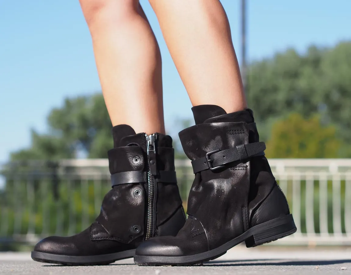 Black leather boots, Genuine women's extravagant leather footwear.